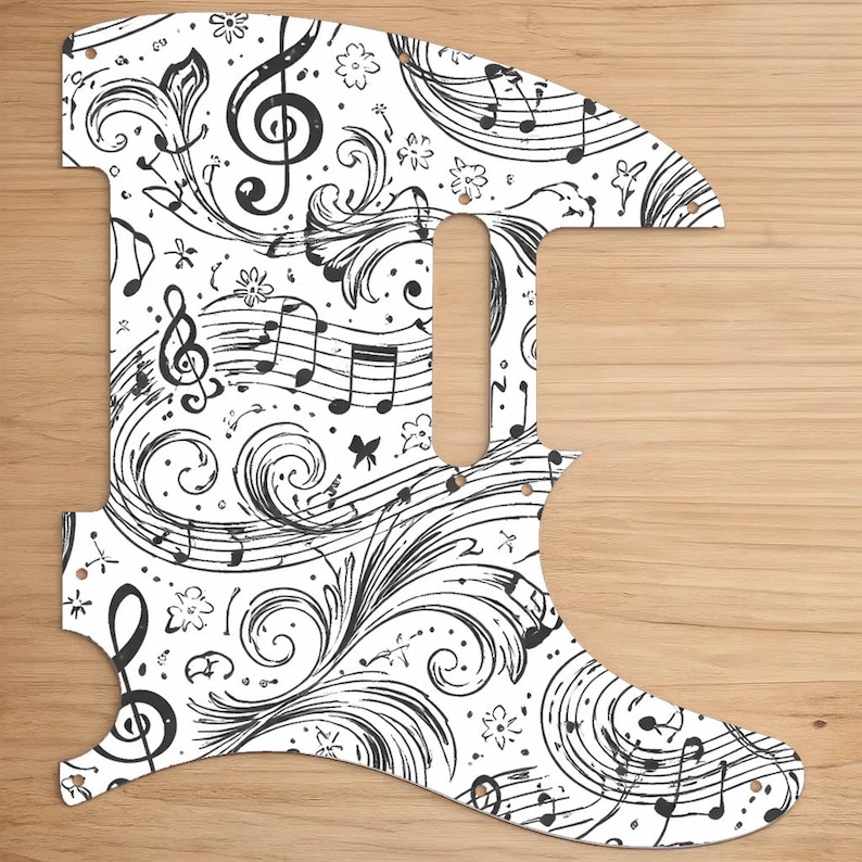May include: White guitar pickguard with a black musical notes and floral design. The pickguard features treble clefs, musical notes, and decorative swirls. The design is a detailed, artistic pattern, suitable for musicians and music enthusiasts.