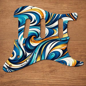 Puede incluir: Un golpeador de guitarra con un dise&ntilde;o abstracto vibrante. El golpeador presenta un patr&oacute;n arremolinado de colores azul, blanco y naranja. Tiene tres recortes para pastillas y varios orificios para tornillos para montarlo en una guitarra el&eacute;ctrica.
