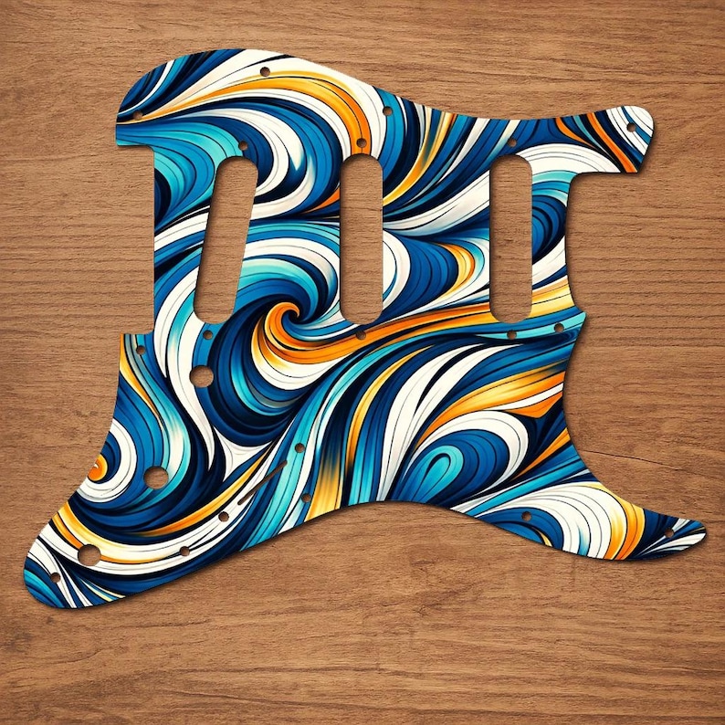 Puede incluir: Un golpeador de guitarra con un dise&ntilde;o abstracto vibrante. El golpeador presenta un patr&oacute;n arremolinado de colores azul, blanco y naranja. Tiene tres recortes para pastillas y varios orificios para tornillos para montarlo en una guitarra el&eacute;ctrica.