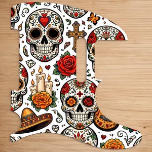 May include: A guitar pickguard featuring a Day of the Dead design. The white pickguard is adorned with colorful sugar skulls, roses, candles, and a sombrero. The design includes a cross, hearts, and floral patterns.