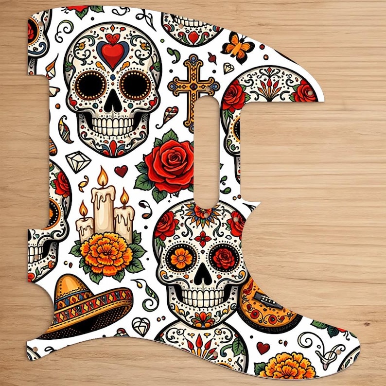 May include: A guitar pickguard featuring a Day of the Dead design. The white pickguard is adorned with colorful sugar skulls, roses, candles, and a sombrero. The design includes a cross, hearts, and floral patterns.
