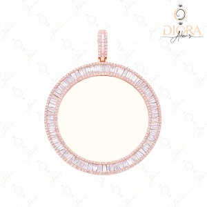 May include: Rose gold pendant with a circular design, encrusted with baguette-cut and round-cut clear crystals. The pendant has a bail at the top for a chain. The jewelry piece is set against a white background.