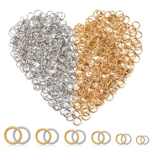 May include: An assortment of silver and gold-colored jump rings arranged in a heart shape. Several pairs of jump rings are displayed below the heart. These jewelry-making supplies are ideal for crafting earrings, bracelets, and necklaces.