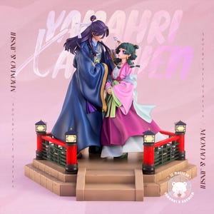 May include: A detailed figurine of two anime characters, a man in a blue robe and a woman in a pink and green outfit, standing on a decorative platform. The platform has red railings and small lanterns. The background is pink with text.