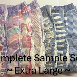 May include: A set of six adult nappies in various patterns, including floral, geometric, and striped designs. The nappies are labelled "Complete Sample Sets ~Extra Large~."