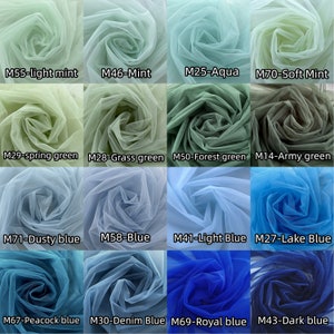 May include: A collection of 12 tulle fabric swatches in various shades of green and blue. The swatches are arranged in a grid pattern and labeled with their corresponding color names and codes. The colors include light mint, mint, aqua, soft mint, spring green, grass green, forest green, army green, dusty blue, blue, light blue, lake blue, peacock blue, denim blue, royal blue, and dark blue.