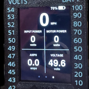 May include: Digital display showing readings for volts, amps, and battery percentage. The screen displays "0" for MPH, input power, and motor power. The voltage reads 49.6 volts, and the amps read 0.0 amps.