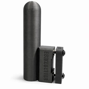 May include: A dark gray, cylindrical object with a rounded top, connected to a rectangular block with the text "EBIKEBETTER". The object appears to be made of a textured material, possibly plastic or metal. The design suggests a mechanical or industrial component.