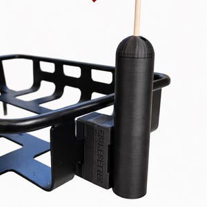 May include: Black metal bicycle basket with a flag holder. The holder has a small American flag with red and white stripes. The text "EBIKEBETTER" is visible on the mounting bracket.