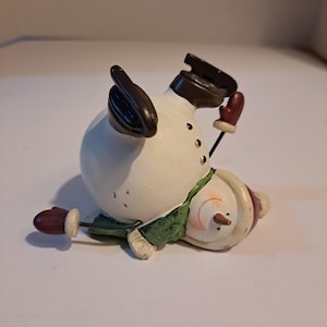 Snowman on ice figurine