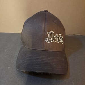 May include: Black baseball cap with a white embroidered logo that says "Driven".