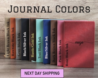 May include: A selection of ten leather-bound journals in various colors, including light brown, rawhide, gray, black, teal, blue, dark brown, pink, and rose. Each journal has black ink lettering on the cover, indicating the color and ink combination. The text "JOURNAL COLORS" is displayed at the top of the image. The text "NEXT DAY SHIPPING" is displayed in a white rectangle with a pink border at the bottom of the image. The journal on the far right has the name "maya" written in cursive on the cover.