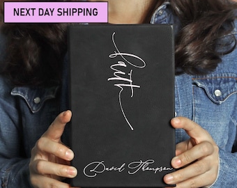 May include: A black leather journal with the word "Faith" written in white cursive script. The journal is personalized with the name "David Thompson" in white cursive script.