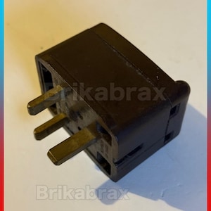 May include: A dark brown Bakelite 3-pin electrical plug with three rectangular metal prongs. The text BAKELITE 3 PIN PLUG SOLD UNTESTED is displayed at the top, with One Supplied and Please Read Description at the bottom of the image.