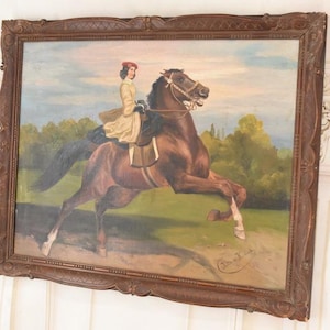 Pu&ograve; includere: Un dipinto a olio antico in una cornice di legno scuro raffigura una persona a cavallo di un cavallo marrone. Il cavaliere indossa un cappotto giallo e un cappello rosso. Il cavallo &egrave; in movimento, con le zampe anteriori sollevate. Lo sfondo mostra un campo verde e alberi.