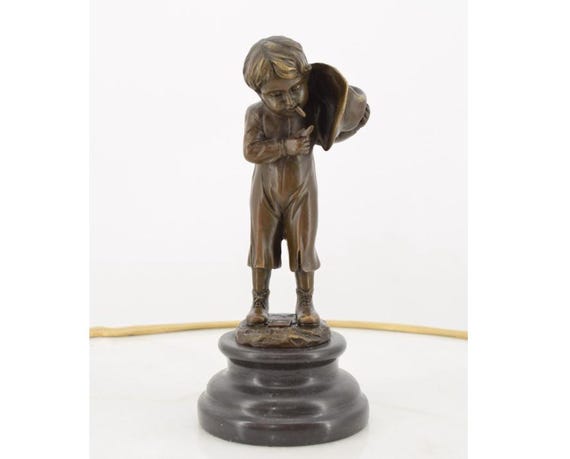 cigarette statue Frank Sinatra finds a creative way to spark a in 1943. The issue of The Saturday Evening Post magazine tucked under the statue's arm is dated August 28th, 1943 featuring artwork statue of man smoking cigarette