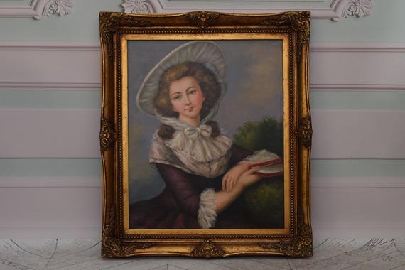金色のフレームに収められた油彩の少女の肖像画。 額縁だけでも価値