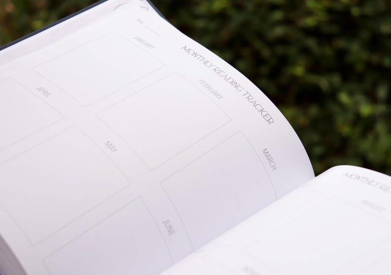 May include: A white monthly reading tracker with spaces to log books read for each month of the year. The months are labelled January through June.