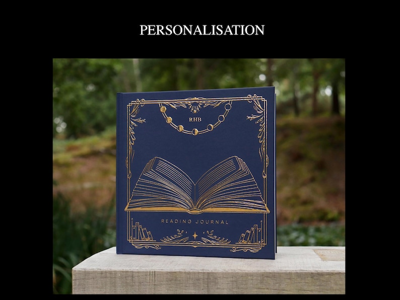 May include: A navy blue reading journal with gold foil accents. The cover features a stylized illustration of an open book with a decorative border and the words "Reading Journal".