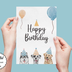 K&ouml;nnte beinhalten: Eine wei&szlig;e Karte mit dem Text "Happy Birthday" in schwarzer Schrift. Am unteren Rand der Karte befinden sich drei Hunde mit Partyh&uuml;ten. Die Hunde sind ein Husky, ein Dalmatiner und ein Golden Retriever. Oben auf der Karte befinden sich zwei Ballons, einer in Pfirsich und einer in Blau.