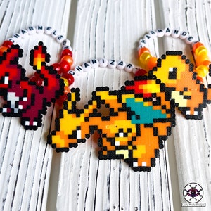 May include: Three beaded bracelets with the names "Charmeleon", "Charizard", and "Charmander" spelled out in white beads. Each bracelet features a pixelated image of the corresponding Pokemon character.