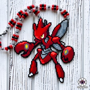 May include: A red and grey pixel art necklace featuring a Pokemon character. The necklace is made of beads and has a black and silver chain.