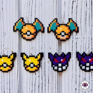 May include: Six pairs of pixel art earrings featuring characters from the Pokemon franchise. The earrings are made of colorful plastic beads and are shaped like Pikachu, Jolteon, and Gengar.