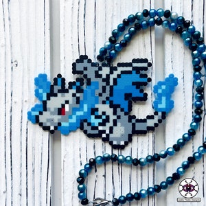 May include: A blue and gray pixel art dragon necklace with a blue and black beaded chain. The dragon is made of perler beads and is a popular video game character.