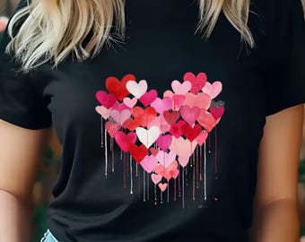 Könnte beinhalten: Schwarzes T-Shirt mit einem Aquarell-Herz-Design, das aus roten und rosa Herzen besteht. Das Herz hat einen Tropfeffekt mit weißer Farbe. Ein romantisches und künstlerisches Design.