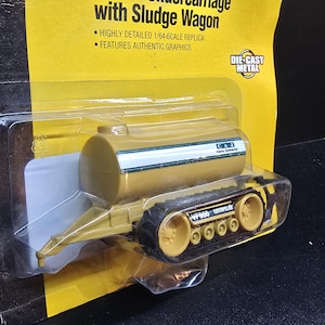 May include: A set of three ceramic mugs with a speckled, matte finish. The mugs are in shades of cream, light gray, and dark gray. Each mug has a simple, minimalist design and a rounded handle.