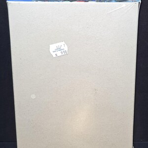 May include: A rectangular cardboard model kit box wrapped in clear plastic. The top edge features blue and white text including the Japanese characters ガンダムレオパルドD and the number 09. A small white circular price sticker is attached to the front.