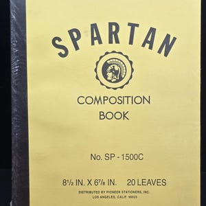 May include: A yellow Spartan composition book with a black spine. The cover features the text SPARTAN, COMPOSITION BOOK, No. SP-1500C, 21.59 cm x 17.46 cm, 20 leaves, and a circular logo of a helmeted warrior, plus distribution information.