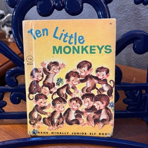 May include: A vintage Ten Little Monkeys Rand McNally Junior Elf book with a yellow cover featuring an illustration of ten brown monkeys. The cover includes the text Ten Little Monkeys, the price 15 cents, and the number 8044 in the corner.
