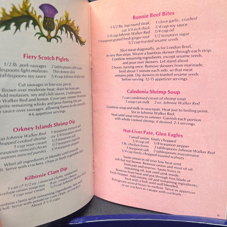 May include: Open cookbook page with recipes for Scottish dishes. Recipes include Fiery Scotch Piglets, Orkney Islands Shrimp Dip, and Bonnie Beef Bites. The page features text and a thistle illustration.