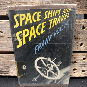 May include: A vintage book titled "Space Ships and Space Travel" by Frank Ross Jr. The cover is black with yellow and blue text and a detailed illustration of a spaceship. The book is a revised edition.