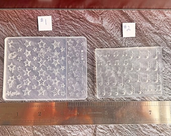 Moldes de silicona transparentes con forma de estrellas o notas musicales en miniatura - 2 opciones