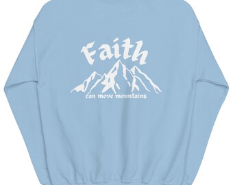 May include: Light blue sweatshirt with the words "Faith" and "can move mountains" in white script and a mountain graphic. The sweatshirt is a crew neck style and made of a soft material.