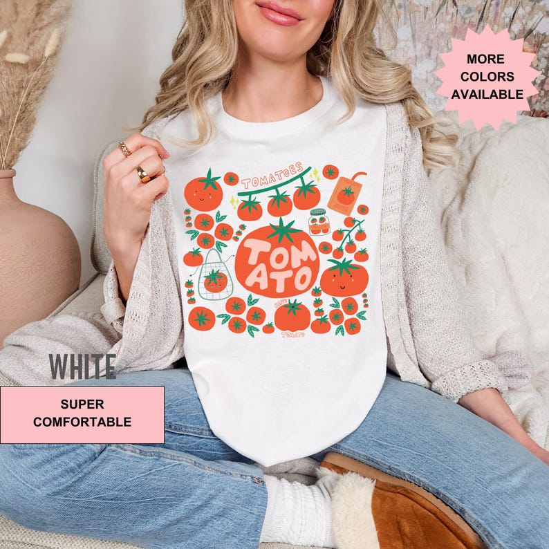 May include: White t-shirt with a graphic of red tomatoes, green leaves, and the text "TOMATOES" and "TOMATO".