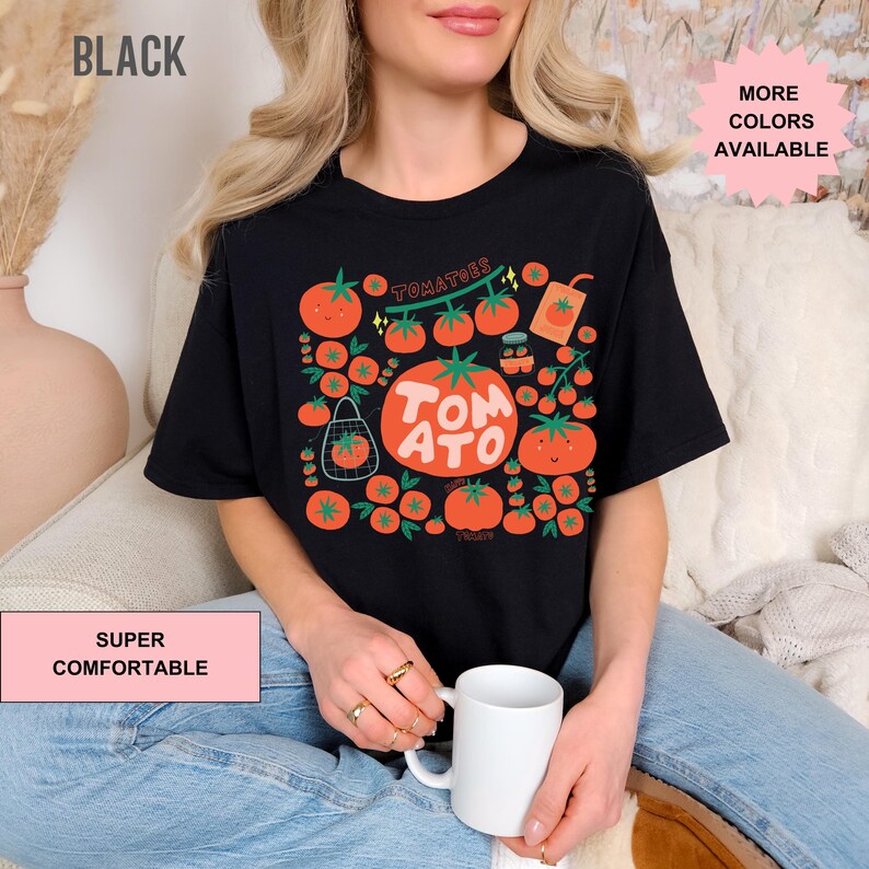 May include: A black t-shirt with a graphic of tomatoes, a vine, and the text "TOMATOES TOMATO".