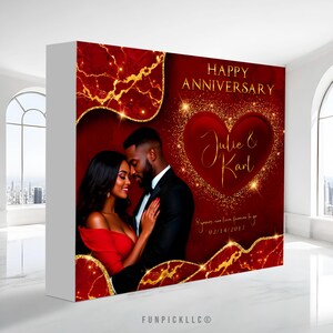 May include: A red and gold anniversary backdrop with a couple embracing. The words "Happy Anniversary" and the names "Julie & Karl" are displayed. The backdrop includes a heart shape and the date 02/14/2017.