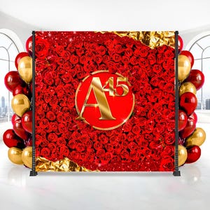 May include: A backdrop featuring a vibrant red rose pattern with a gold-colored "A45" emblem. The backdrop is framed by a black stand and adorned with red and gold balloons, creating a festive atmosphere.