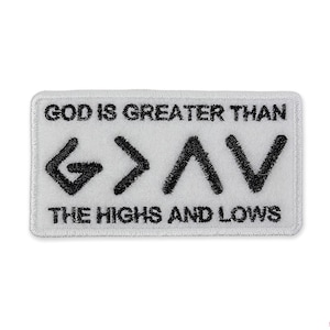 May include: White embroidered patch with black text that reads "God is greater than the highs and lows" and a graphic of a stylized "G>AV".