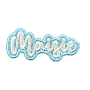 May include: Light blue iron-on patch with the name "Maisie" in white cursive lettering.