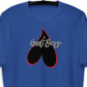 May include: A royal blue t-shirt with a black heart outlined in red. The text "i love t-dayz" is written in white cursive inside the heart.