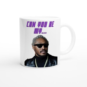 May include: White ceramic mug with a purple text overlay that reads "Can you be my..." and a photo of a man wearing sunglasses and a black leather jacket.