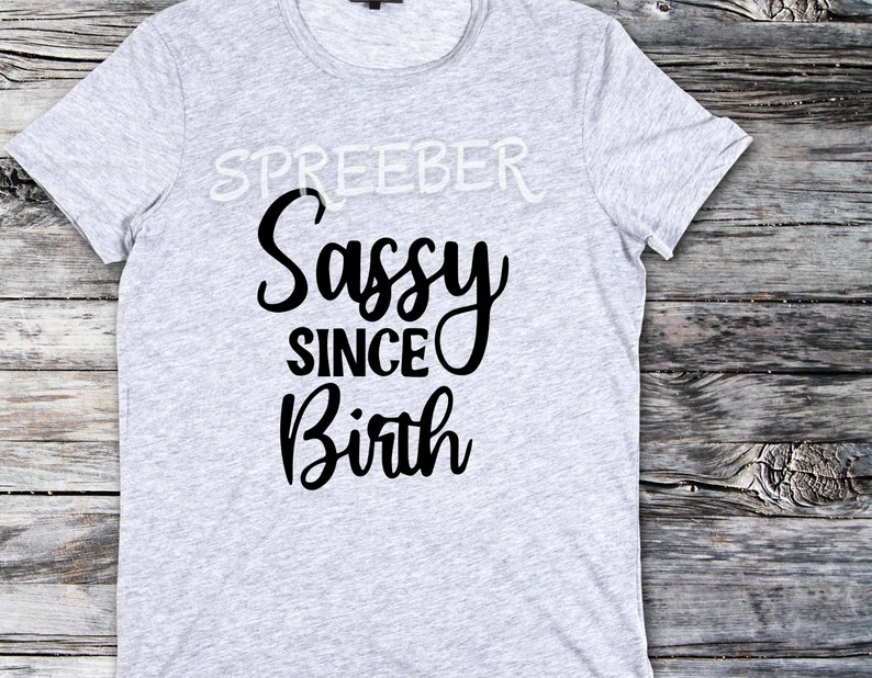 May include: Gray t-shirt with black text that reads "Sassy Since Birth".
