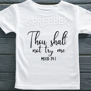 May include: White t-shirt with black text that reads "Thou shalt not try me MOOD 24:7".
