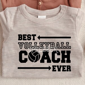 May include: A light gray t-shirt with black text that reads "Best Volleyball Coach Ever" with a black arrow pointing to the left above the word "Best" and a black arrow pointing to the right below the word "Ever". A black volleyball is between the words "Coach" and "Ever".