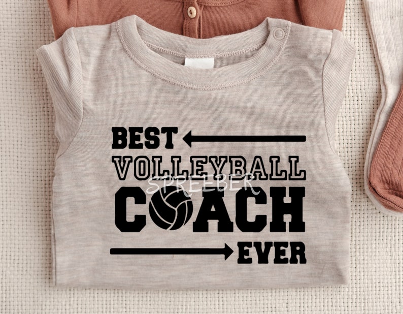 May include: A light gray t-shirt with black text that reads "Best Volleyball Coach Ever" with a black arrow pointing to the left above the word "Best" and a black arrow pointing to the right below the word "Ever". A black volleyball is between the words "Coach" and "Ever".