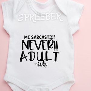 May include: White baby onesie with black text that reads "Me sarcastic? Never!! Adult-ish".